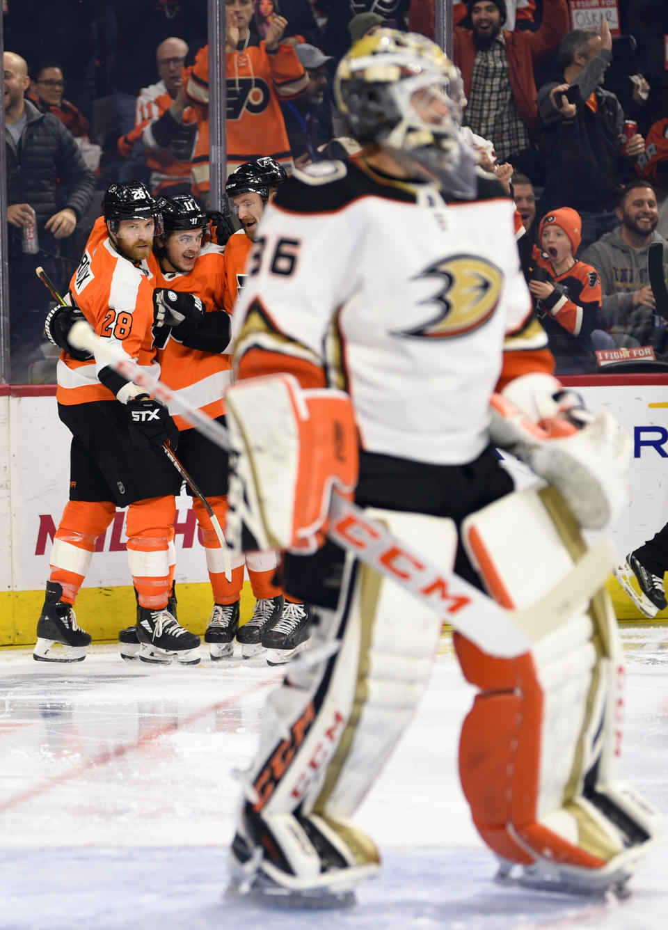 Philadelphia Flyers' Claude Giroux, left, celebrates with teammates after scoring a goal past Anaheim Ducks goaltender John Gibson during the second period of an NHL hockey game, Tuesday, Dec. 17, 2019, in Philadelphia. (AP Photo/Derik Hamilton)