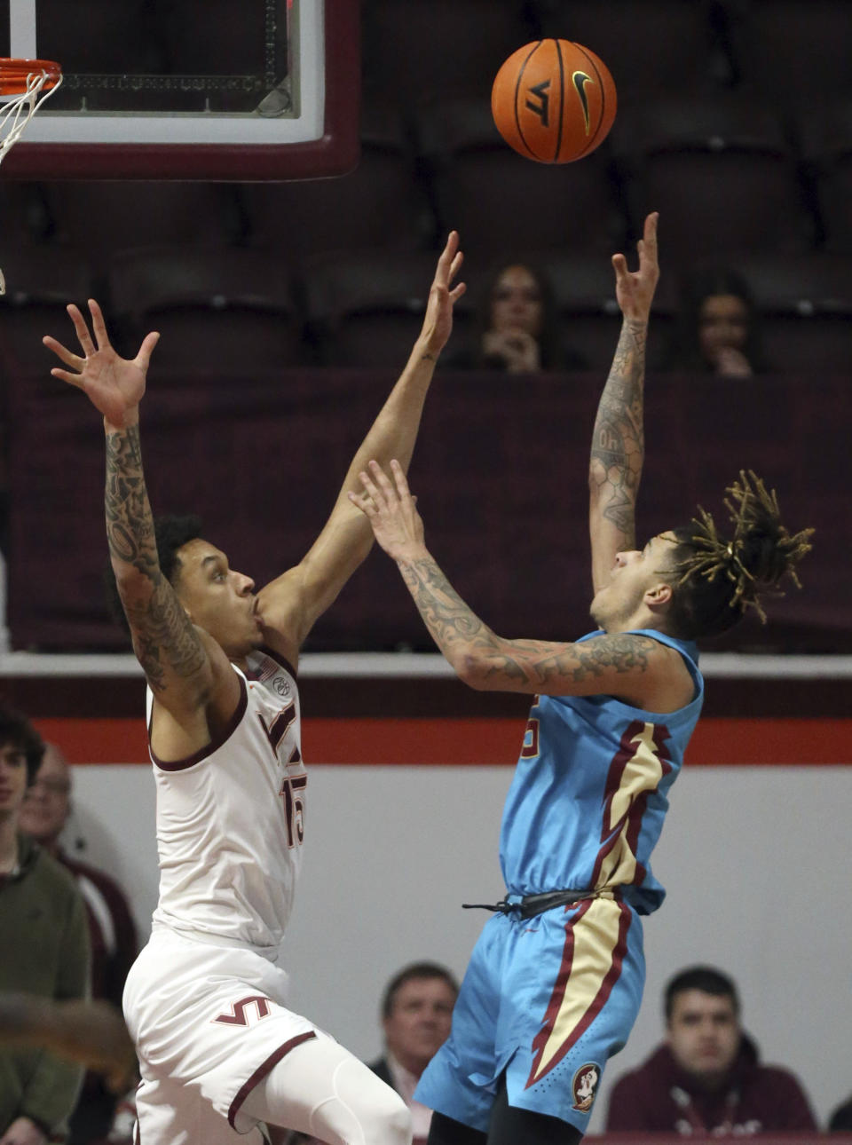 Florida State's De'Ante Green (5) shoots while defended by Virginia Tech's Lynn Kidd (15) in the first half of an NCAA college basketball game Tuesday, Feb. 13, 2024, in Blacksburg, Va. (Matt Gentry/The Roanoke Times via AP)