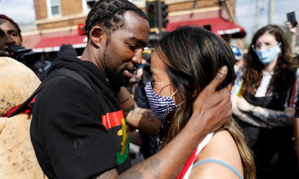 Michael Wilson embraces Anthea Yur during an Asian solidarity rally dedicated to Daunte Wright and George Floyd, in Minneapolis, Minnesota, 18 April 2021.