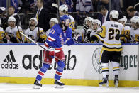 New York Rangers center Mika Zibanejad reacts after scoring a goal as he skates past the bench of the Pittsburgh Penguins during the third period in Game 7 of an NHL hockey Stanley Cup first-round playoff series, Sunday, May 15, 2022, in New York. (AP Photo/Adam Hunger)