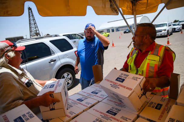 PHOTO: Volunteers begin to hand out 12-liter boxes of emergency drinking water to residents in need after a broken water main left the majority of Ector County without clean running water in Odessa, Texas, June 14, 2022. (Eli Hartman/AP)