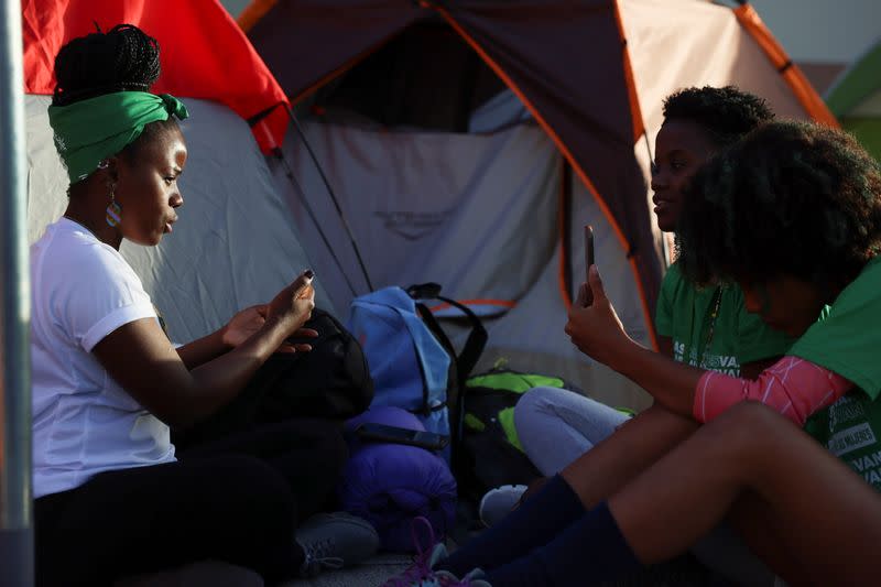 Abortion rights activists sit outside tents set up in front of the National Palace during a protest to pressure parliament over a proposed reform to the penal code that could end the total ban on abortion, in Santo Domingo