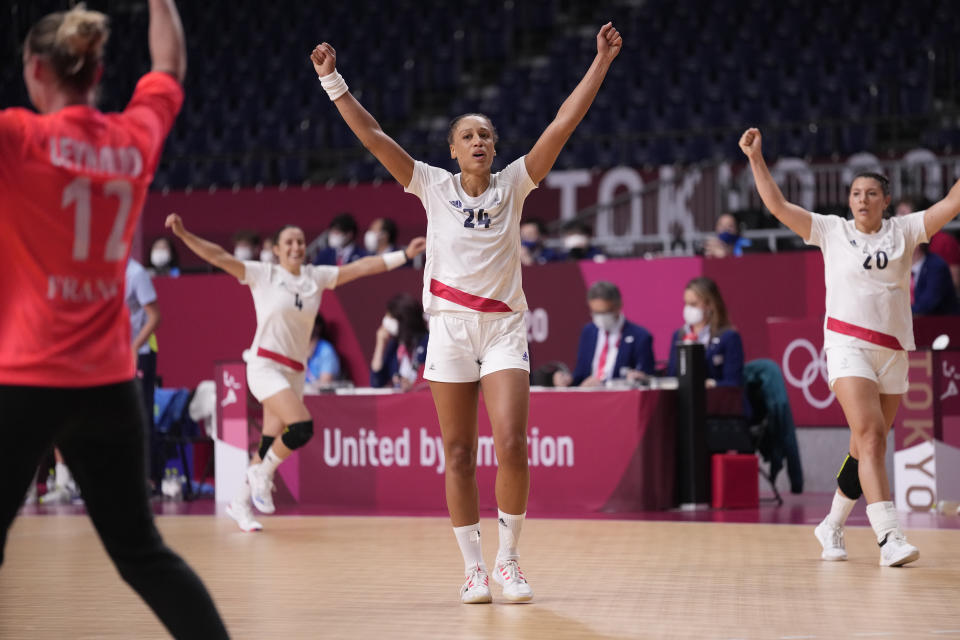 France's team players celebrate during the women's semifinal handball match between France and Sweden at the 2020 Summer Olympics, Friday, Aug. 6, 2021, in Tokyo, Japan. (AP Photo/Pavel Golovkin)