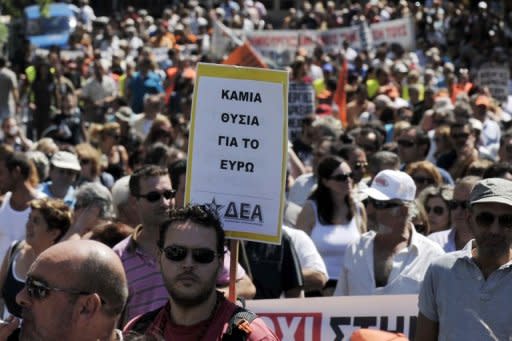 Municipality workers march in central Athens on Wednesday as part of a 48-hour strike against spending cutbacks and the government's latest austerity measures. The sign in the foreground reads 'No sacrifies for the Euro'