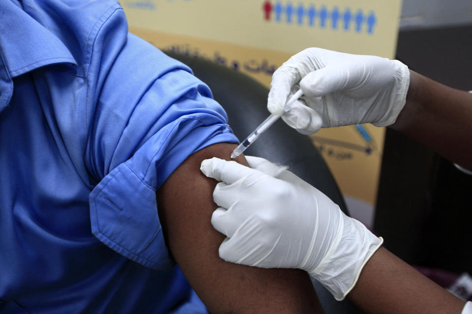 A man receives a dose of the Oxford-AstraZeneca COVID-19 coronavirus vaccine at the Jabra Hospital for Emergency and Injuries in Sudan's capital Khartoum on March 9, 2021. - Sudan is the first in the Middle East and North Africa to receive vaccines through COVAX, a UN-led initiative that provides jabs to poor countries, according to children's agency UNICEF. The first batch to arrive was comprised of 828,000 doses of the AstraZeneca vaccine, which are planned to cover 414,000 frontline health care workers across the country, according to health officials. (Photo by Ebrahim HAMID / AFP) (Photo by EBRAHIM HAMID/AFP via Getty Images)