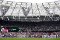 Players and fans commemorate Jimmy Greaves, one of England's greatest goal-scorers, ahead of the English Premier League soccer match between West Ham United and Manchester United at the London Stadium in London, England, Sunday, Sept. 19, 2021. Greaves who was prolific for Tottenham, Chelsea and AC Milan has died. He was 81. With 266 goals in 379 appearances, Greaves was the all-time record scorer for Tottenham, which announced his death on Sunday, Sept. 19, 2021. (AP Photo/Ian Walton)