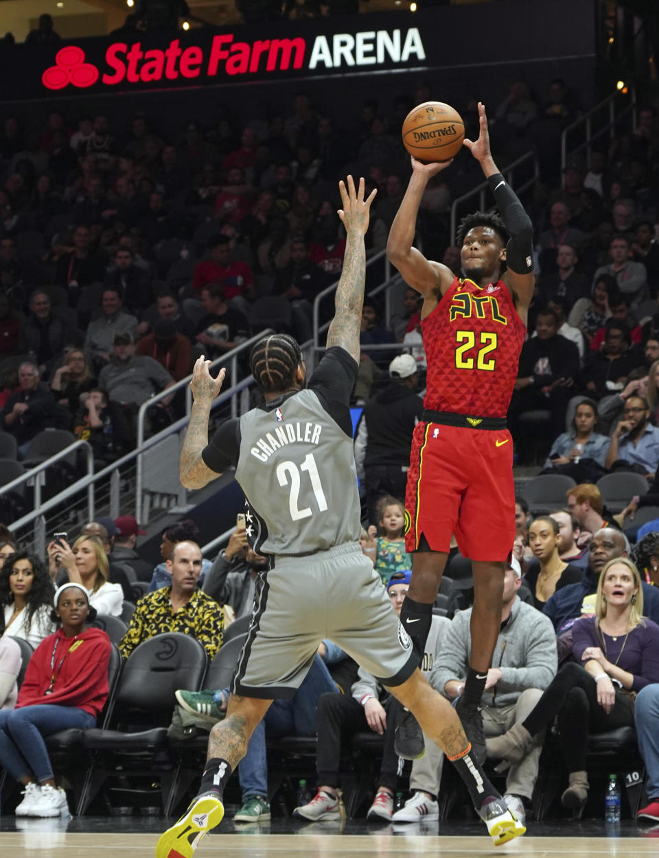 Atlanta Hawks' Cam Reddish (22) shoots for three points over Brooklyn Nets' Wilson Chandler (21) in the second half of an NBA basketball game Friday, Feb. 28, 2020, in Atlanta. (AP Photo/Tami Chappell)