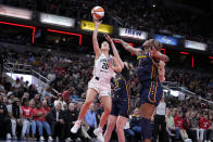 New York Liberty guard Sabrina Ionescu (20) shoots over Indiana Fever forward Aliyah Boston (7) in the first half of a WNBA basketball game, Thursday, May 16, 2024, in Indianapolis. (AP Photo/Michael Conroy)