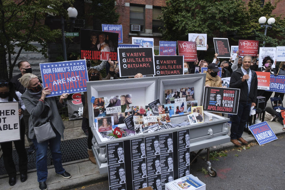 FILE - In this Sunday, Oct. 18, 2020 file photo, families of COVID-19 victims who passed away in New York nursing homes gather in front of the Cobble Hill Heath Center in the Brooklyn borough of New York, to demand New York State Gov. Andrew Cuomo's apologize for his response to clusters in nursing homes during the pandemic. More than 9,000 recovering coronavirus patients in New York state were released from hospitals into nursing homes at the height of the pandemic under a controversial order that was scrapped amid criticisms it accelerated outbreaks, according to new records obtained by The Associated Press. (AP Photo/Yuki Iwamura)