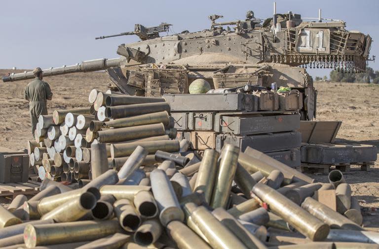 Israeli shell cases are stacked up at an army deployment area near the border with the Gaza Strip, on July 31, 2014