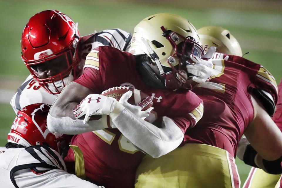Louisville defensive lineman Jared Dawson (93) commits a face mask penalty on Boston College running back Travis Levy (23) during the second half of an NCAA college football game, Saturday, Nov. 28, 2020, in Boston. (AP Photo/Michael Dwyer)