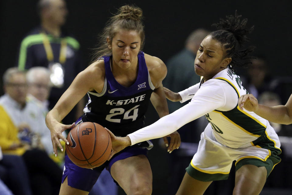 Baylor guard Juicy Landrum, right, reaches in against Kansas State guard Emilee Ebert, left, in the first half of an NCAA college basketball game, Saturday, Feb. 29, 2020, in Waco, Texas. (AP Photo/Rod Aydelotte)