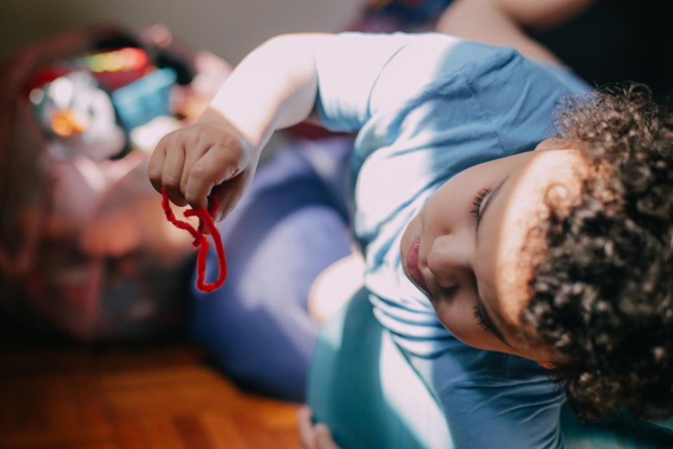 Tristan Diaz, now 8, likes to play with manipulatives like pipe cleaners to keep his hands occupied. (Marianna McMurdock)