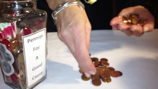 Ronna Goldberg counts donated pennies donated to Winnipeg Harvest. 