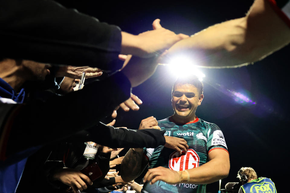 Latrell Mitchell (pictured) high-fives the fans.