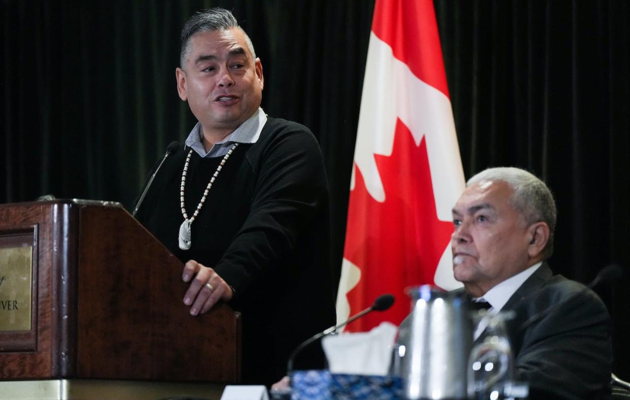 Former Tk'emlúps te Secwépemc Chief Shane Gottfriedson, left, speaks as hiwus (Chief) Warren Paull, of the shíshálh Nation, listens during a news conference, in Vancouver, on Jan. 21, 2023. THE CANADIAN PRESS/Darryl Dyck