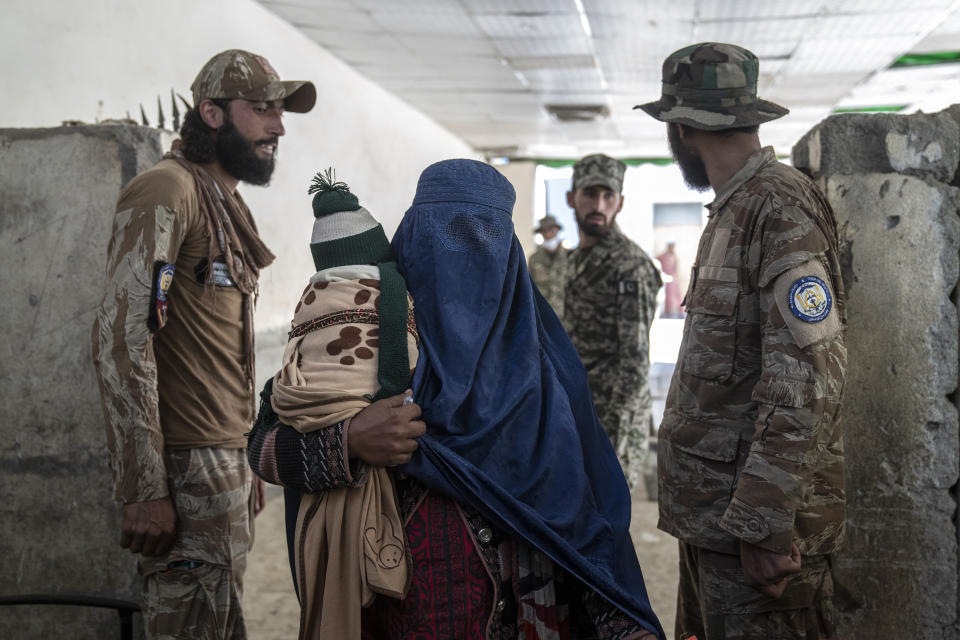 An Afghan refugee woman returns to Afghanistan through the Pakistan-Afghanistan border in Torkham, Afghanistan, Friday, Nov. 3, 2023. Many Afghan refugees arrived at the Torkham border to return home shortly before the expiration of a Pakistani government deadline for those who are in the country illegally, or face deportation. (AP Photo/Ebrahim Noroozi)