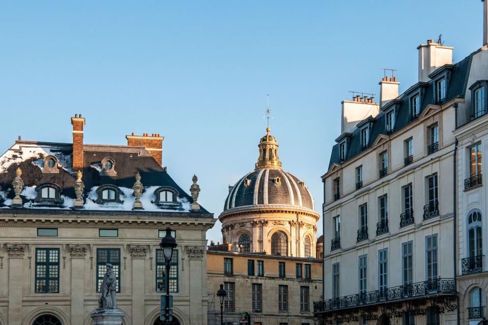 Buildings in Paris during winter with some snow and golden sunlight