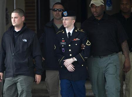 U.S. Army Pfc. Bradley Manning (C) is escorted out of a courthouse during his court martial at Fort Meade in Maryland, August 20, 2013. REUTERS/Jose Luis Magana