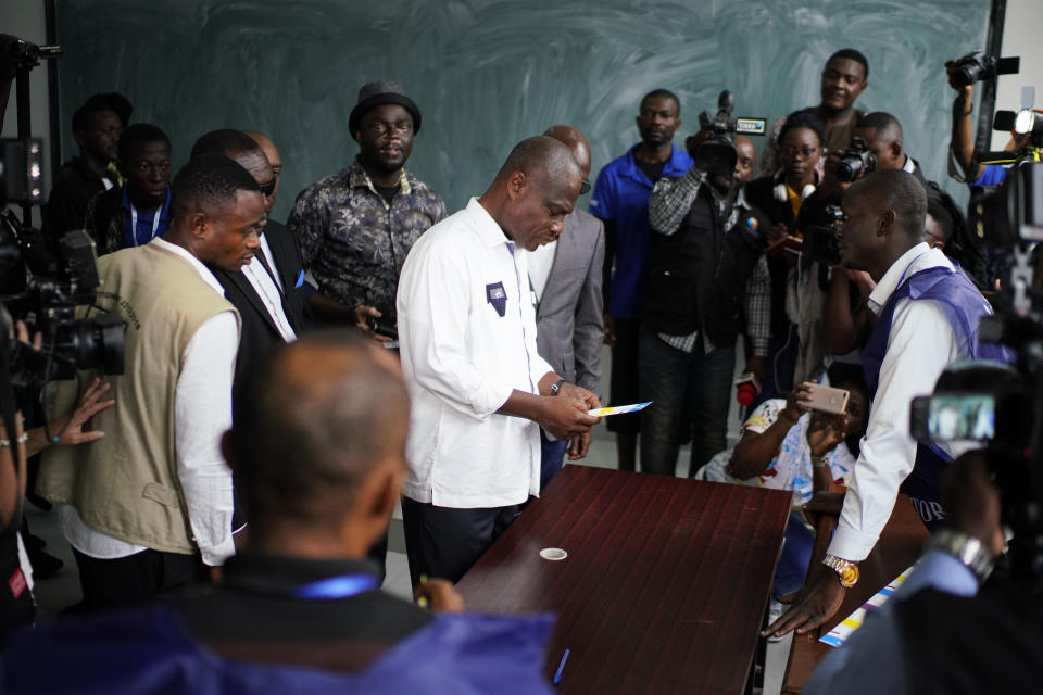 Congolese opposition presidential candidate Martin Fayulu, center, arrives to cast his vote Sunday, Dec. 30, 2018 in Kinshasa, Congo. Forty million voters are registered for a presidential race plagued by years of delay and persistent rumors of lack of preparation. (AP Photo/Jerome Delay)
