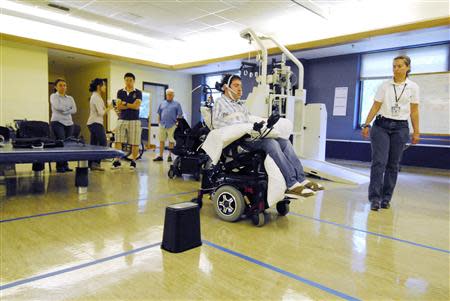 Paralyzed patient Jason Disanto pilots a wheelchair using the Tongue Drive System at the Shepherd Center in Atlanta, Georgia April 6, 2011. REUTERS/Gary Meek/Shepherd Center/Handout via Reuters