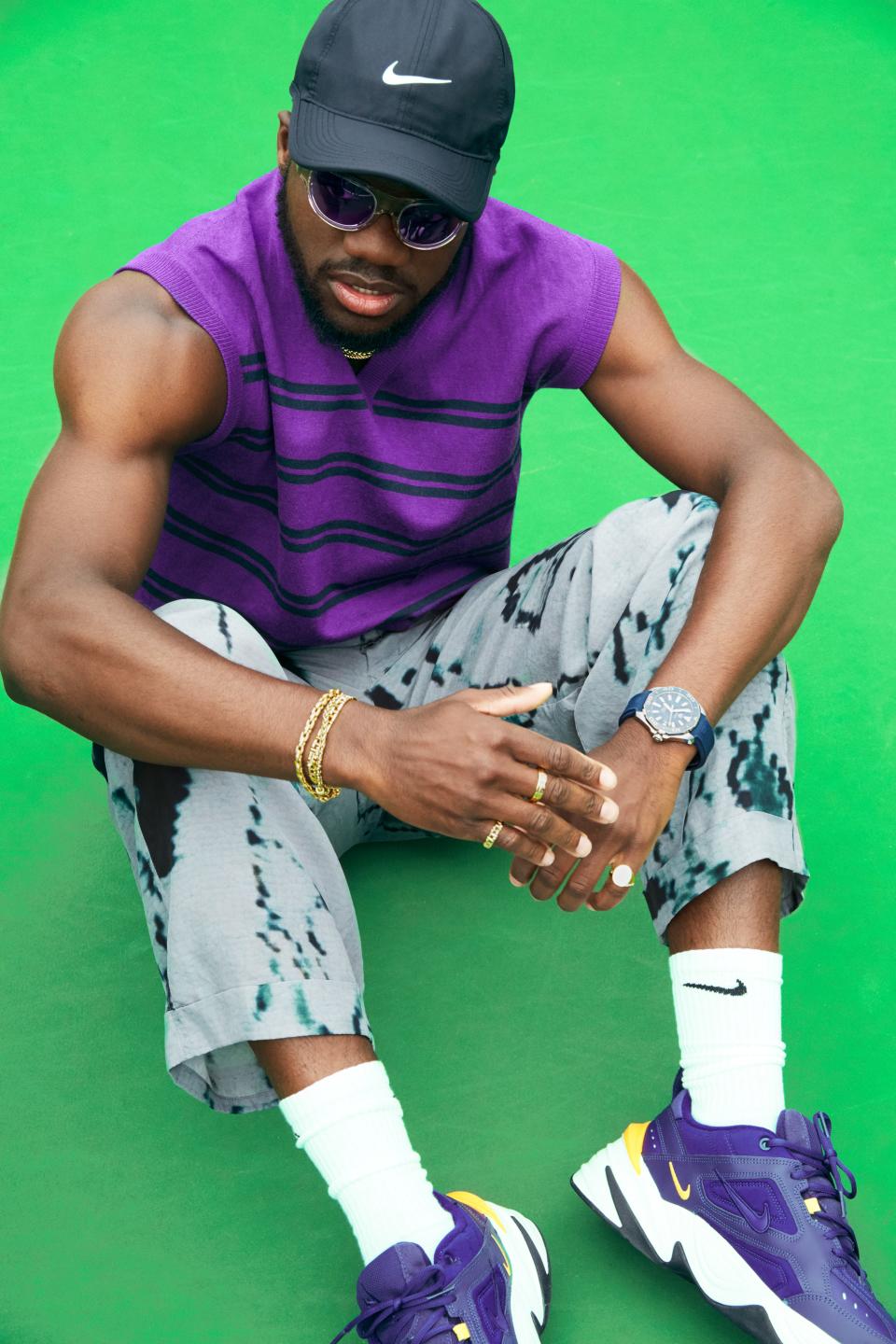 <cite class="credit">Vest, $1,195, by Lanvin / Pants, $1,895, by Giorgio Armani / Sneakers, $100, socks, $14 (for three pairs), and hat, $24, by Nike / Sunglasses, $230, by Retrosuperfuture / Watch, $2,500, by TAG Heuer / Ring (on left hand): $270, by Phira; rings (on right hand): $1,350 (pinkie finger), and $1,600 (middle finger), by Tiffany & Co.</cite>