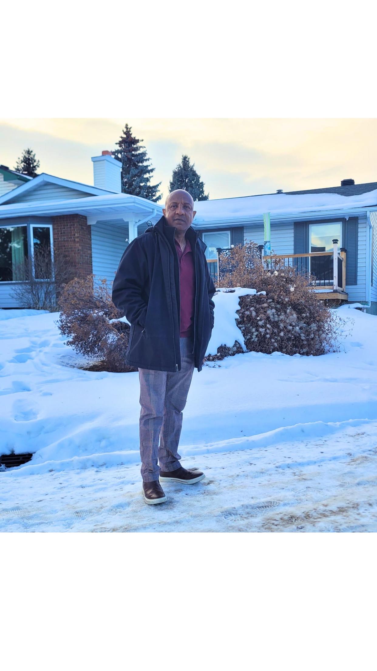 Dawit Mulugeta stands in front of the house he bought in Calgary's Woodbine neighbourhood and renovated as a small-scale seniors home. (Submitted by Dawit Mulugeta - image credit)