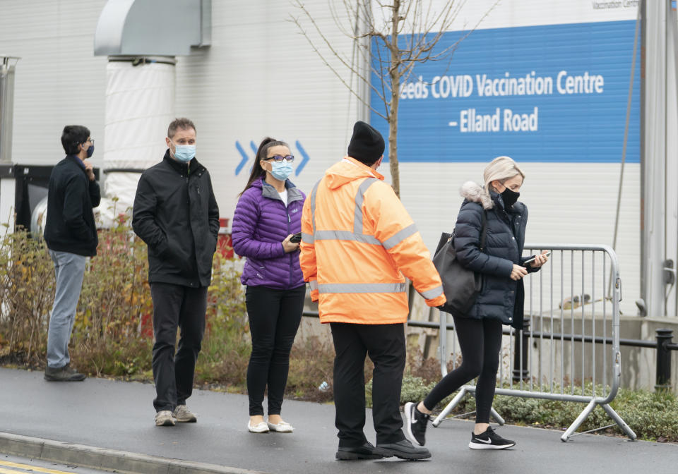 People arrive at the Elland Road Leeds COVID Vaccination Centre, as the coronavirus booster vaccination programme continues across the UK. Despite the ramping-up of the booster programme, experts said it would not help in terms of hospitals admissions in the near future, as many would be people who are infected now before immunity has had time to build. Picture date: Monday December 20, 2021.