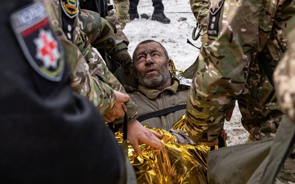 A man is rescued by firefighters after an apartment block was heavily damaged by a missile strike in Pokrovsk - MARKO DJURICA/REUTERS