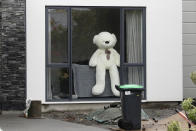 In this Monday, March 30, 2020, photo, a teddy bear sits in a window of a house in Christchurch, New Zealand. New Zealanders are embracing an international movement in which people are placing teddy bears in their windows during coronavirus lockdowns to brighten the mood and give children a game to play by spotting the bears in their neighborhoods. (AP Photo/Mark Baker)