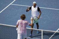 Nick Kyrgios, of Australia, greets Reilly Opelka, of the United States, after Kyrgios won their match at the Citi Open tennis tournament in Washington, Friday, Aug. 5, 2022. The match that was postponed yesterday because of weather. (AP Photo/Carolyn Kaster)