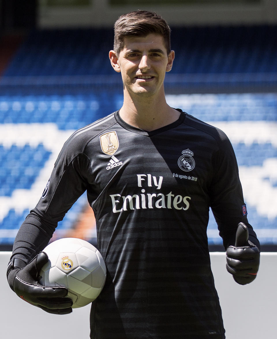 Belgian new Real Madrid soccer player Thibaut Courtois poses for the media during his official presentation for Real Madrid at the Santiago Bernabeu stadium in Madrid, Thursday, Aug. 9, 2018. Chelsea has sold a player — goalkeeper Thibaut Courtois — to Real Madrid. The Belgian was replaced by Kepa Arrizabalaga after Chelsea met the goalkeeper's 80 million euro ($93 million) buyout clause from Athletic Bilbao on Wednesday. (AP Photo/Andrea Comas)