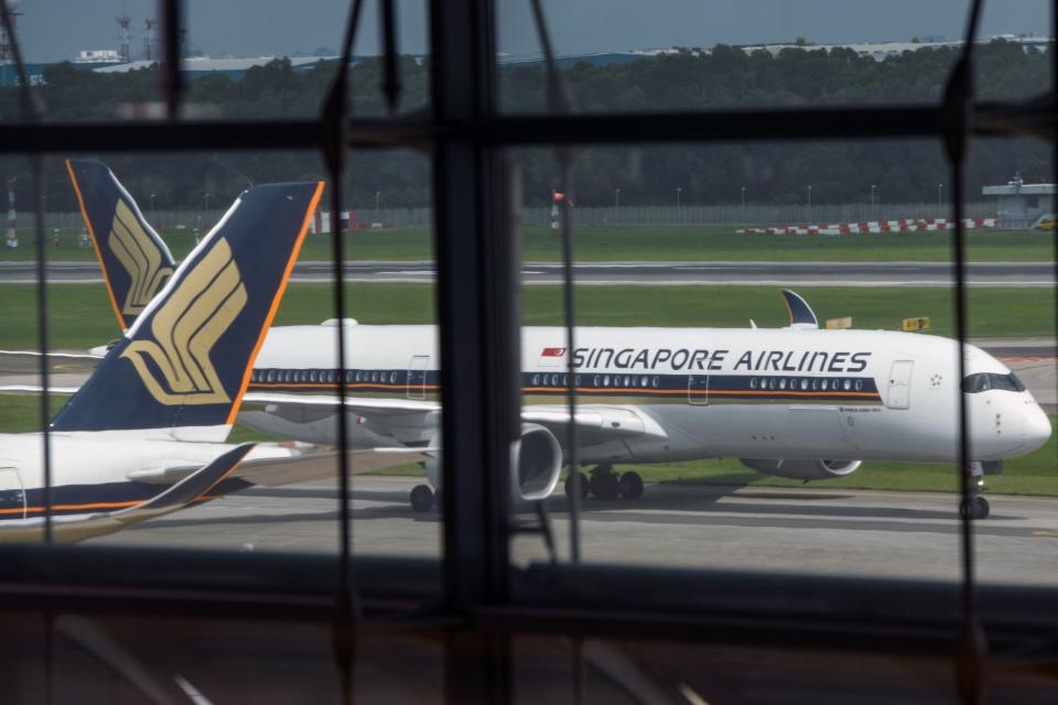 A Singapore Airlines passenger jet taxis along the tarmac as it arrives at Changi International Airport terminal in Singapore on June 8, 2020, as Singapore prepares to reopen its borders after shutting them to curb the spread of the COVID-19 novel coronavirus. (Photo by Roslan RAHMAN / AFP) (Photo by ROSLAN RAHMAN/AFP via Getty Images)