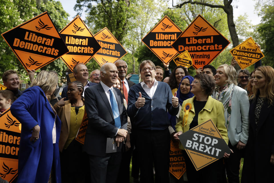 Running for re-election as an MEP, European Parliament Brexit chief Guy Verhofstadt, center, who is the leader of the Alliance of Liberals and Democrats for Europe, speaks as he stands with the leader of the British Liberal Democrats party Vince Cable, center left, as they pose for the media with supporters in Camden Square, London, Friday, May 10, 2019. Verhofstadt on Friday joined British Liberal Democrats who were going to canvas residents in the area. (AP Photo/Matt Dunham)