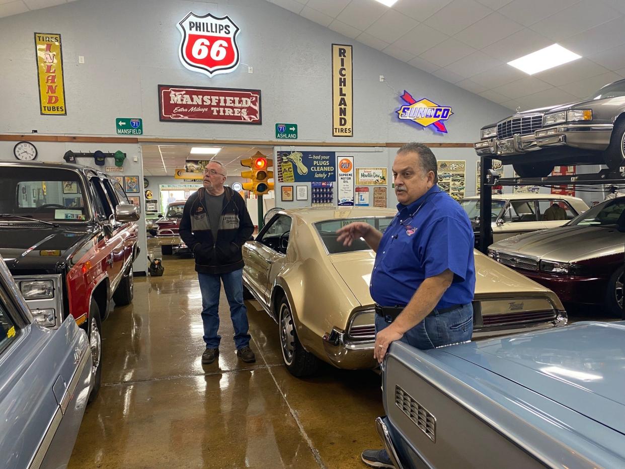 Local businessman and class car collector Johnny Matthes, at right, talks to friend Ed Freiheit about some of the cars in his private museum collection on Ashland Road. Matthes' collection includes cars, signs and more. The museum is not open to the public.