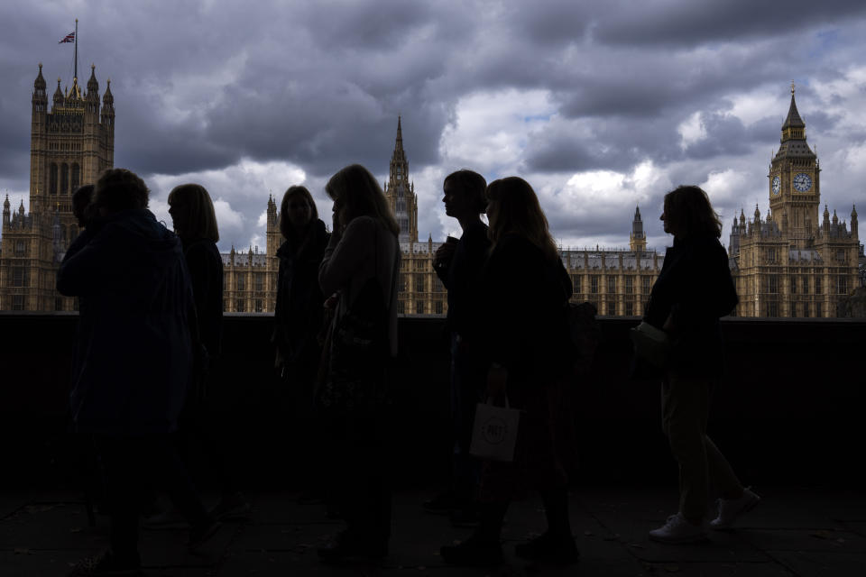 People queue to pay their respect to the late Queen Elizabeth II during the Lying-in State, outside Westminster Hall in London, Thursday, Sept. 15, 2022. The Queen will lie in state in Westminster Hall for four full days before her funeral on Monday Sept. 19.(AP Photo/Nariman El-Mofty)