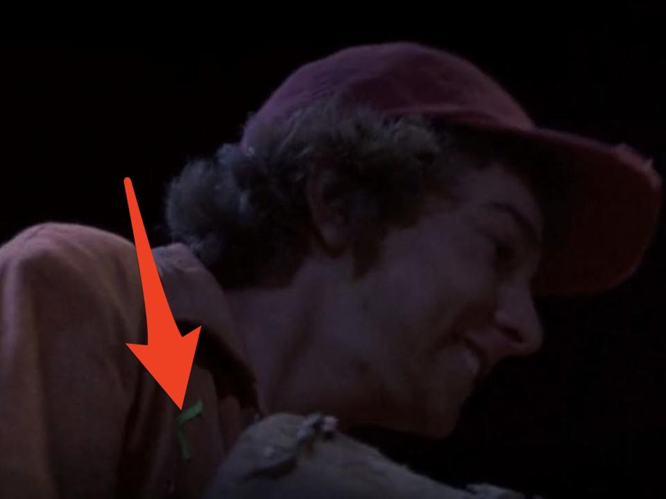 red arrow pointing at green tape on stanley's jumpsuit in a scene from holes