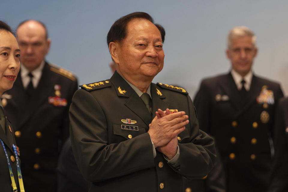 Zhang Youxia, vice chairman of the CPC Central Military Commission, applauds near Steve Koehler, right, commander of the U.S. Pacific Fleet, and Alexander Moiseyev, second from left, Russia's chief of Navy, looks after a group photo before attending the Western Pacific Navy Symposium in Qingdao, eastern China's Shandong province on Monday, April 22, 2024. Zhang, China's second-ranking military leader under Xi Jinping, took a harsh line on regional territorial disputes on Monday, telling the international naval gathering in northeastern China that the country would strike back with force if its interests came under threat. (AP Photo/Ng Han Guan)