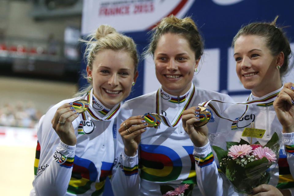 FILE - The Australian team, from left, Melissa Hoskins, Amy Cure, Ashlee Ankudinoff and Annette Emonodson, unseen, pose with their gold medal celebrates during the Women's Team Pursuit race medal ceremony at the Track Cycling World Championships in Saint-Quentin-en-Yvelines, outside Paris, France, on Feb. 19, 2015. Former world champion cyclist Rohan Dennis was reported to have been charged in connection with the death of his wife, Olympic cyclist Melissa Hoskins, who died after being struck by a vehicle while riding in Adelaide. (AP Photo/Michel Euler, File)