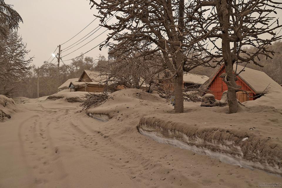 In this photo provided by the Russian Academy of Sciences' Volcanology Institute, volcanic ash covers the ground and houses after the Shiveluch volcano's eruption in Klyuchi village on the Kamchatka Peninsula in Russia, Tuesday, April 11, 2023. The volcano has erupted on Russia's far eastern Kamchatka Peninsula. The eruption early Tuesday of Shiveluch, one of Kamchatka's most active volcanoes, spewed clouds of dust 12 miles into the sky. (Yury Demyanchuk/Russian Academy of Sciences' Volcanology Institute via AP)