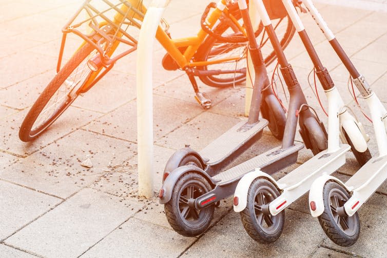 <span class="caption">There are concerns that scooter use may put people off walking.</span> <span class="attribution"><a class="link " href="https://www.shutterstock.com/image-photo/bicycle-electric-scooters-parked-on-city-1304611447" rel="nofollow noopener" target="_blank" data-ylk="slk:Shutterstock/Gorlov-KV;elm:context_link;itc:0;sec:content-canvas">Shutterstock/Gorlov-KV</a></span>