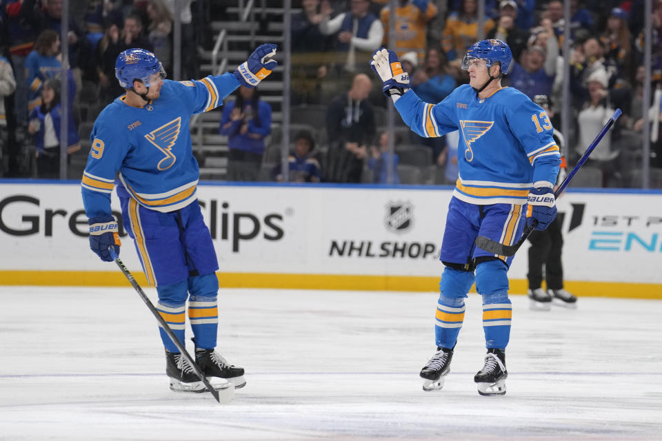 St. Louis Blues' Alexey Toropchenko (13) is congratulated by Pavel Buchnevich after scoring during the third period of an NHL hockey game against the Montreal Canadiens Saturday, Nov. 4, 2023, in St. Louis. (AP Photo/Jeff Roberson)