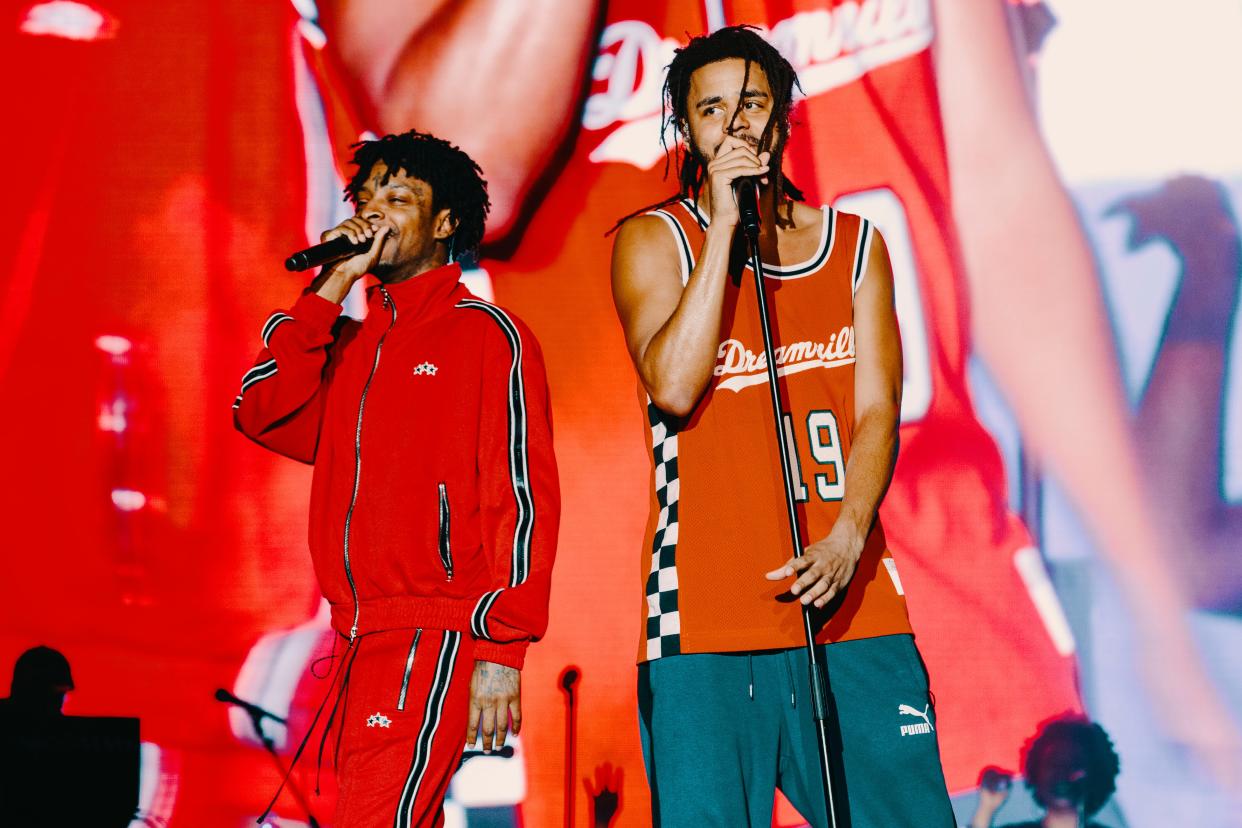 J. Cole, right, performs with 21 Savage, at Dreamville Festival 2019.