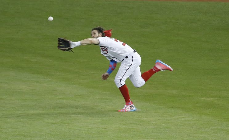 National League's Washington Nationals outfielder Bryce Harper (34) catches a hit by American League's Kansas City Royals Salvador Perez (13), during the second inning at the MLB baseball All-Star Game, Tuesday, July 11, 2017, in Miami. (AP Photo/Wilfredo Lee)