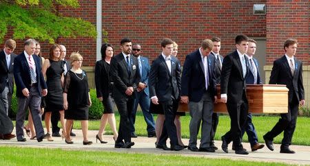 Fred and Cindy Warmbier follow their son's, Otto Wambier, casket to the hearse after his funeral at Wyoming High School in Wyoming, Ohio, U.S. June 22, 2017. REUTERS/John Sommers II