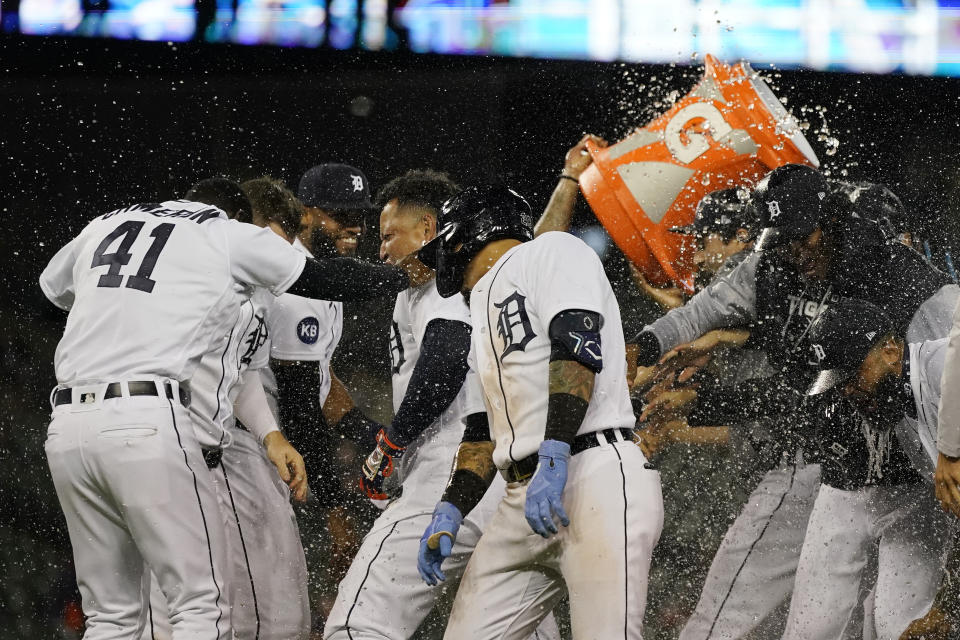 Detroit Tigers designated hitter Miguel Cabrera, center, is doused after scoring the winning run during the ninth inning of a baseball game against the Cleveland Guardians, Thursday, May 26, 2022, in Detroit. (AP Photo/Carlos Osorio)