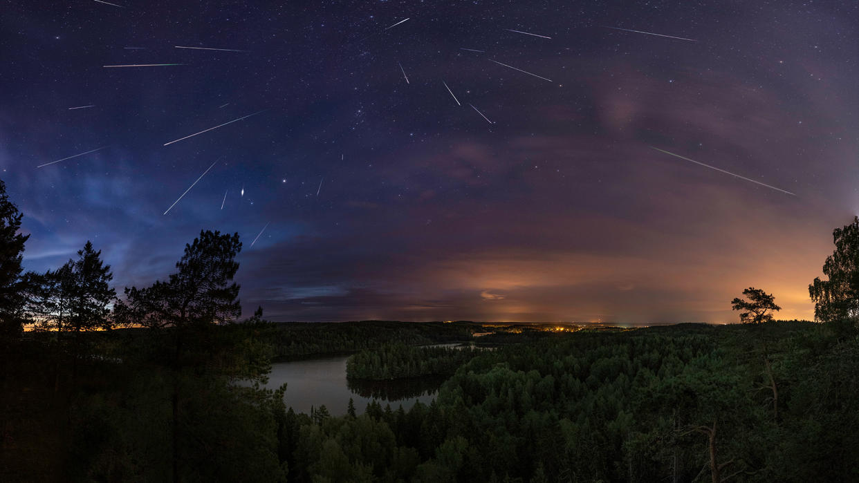  View of night sky with falling meteors. 