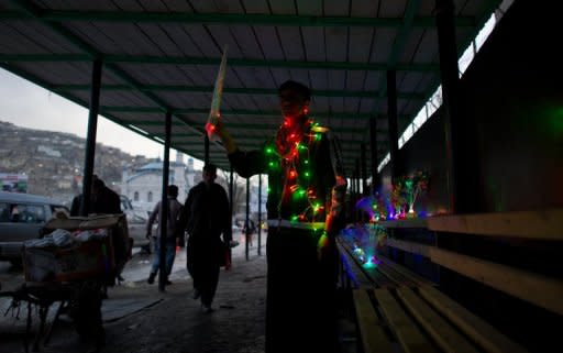 An Afghan vendor sells toys and lights in the old city of Kabul. Afghanistan and the United States signed a deal on special forces operations in the insurgency-wracked country on Sunday, putting Afghans in charge of controversial night raids