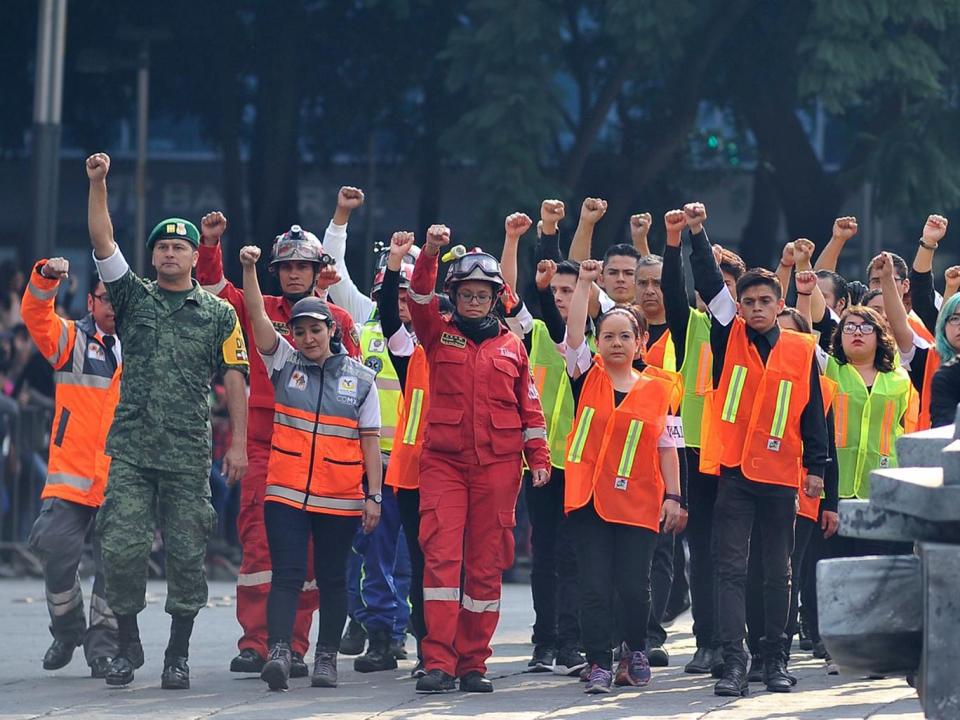 Volunteers who participated in the rescue operations following the September 19 quake in central Mexico take part in the Day of the Dead parade (AFP/Getty Images)