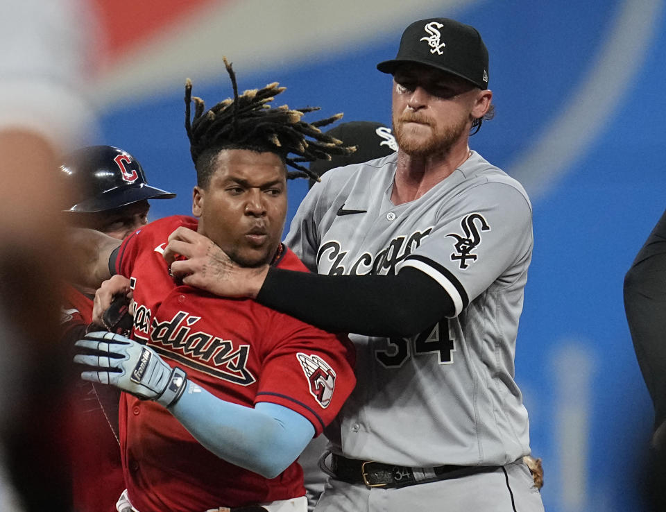 Chicago White Sox's Michael Kopech, right, holds back Cleveland Guardians' Jose Ramirez, second from right, as Ramirez and Tim Anderson fight in the sixth inning of a baseball game Saturday, Aug. 5, 2023, in Cleveland. (AP Photo/Sue Ogrocki)